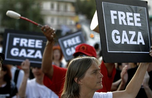 Activists of Gaza flotilla gathering outside the Ministry of Public Order in Athens, Greece, Sunday, July 3, 2011. Organizers of a Gaza-bound flotilla said Sunday they have not abandoned their plans to breach Israel's sea blockade of the territory despite a Greek government ban on their vessels leaving the country's ports. (AP Photo/Petros Karadjias) (AP)