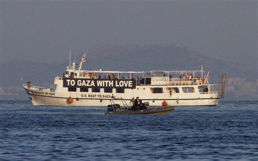 The activist run boat "Audacity of Hope" is escorted by the Greek coast guard in port of Perama, near Athens, Greece, Friday, July 1, 2011. Greece on Friday banned ships heading to the Gaza Strip from leaving Greek ports, and a vessel carrying several dozen American protesters which left port without permission was ordered to return. (AP Photo/Darko Bandic) (AP)