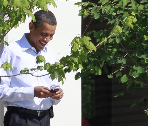 FILE - In this June 3, 2010 file photo, President Barack Obama uses his BlackBerry e-mail device as he walks at Sidwell Friends school in Bethesda, Md. Call him the Digital Candidate: President Barack Obama has asked supporters to use Facebook to declare Im in for his re-election campaign and has begun using Twitter to communicate with his nearly 9 million followers. If Obama broke new ground using email, text messages and the Web to reach voters in 2008, Obama version 2.0 aims to harness the expansive roles that the Internet and social media are playing now in voters lives. (AP Photo/Charles Dharapak, File) (AP)