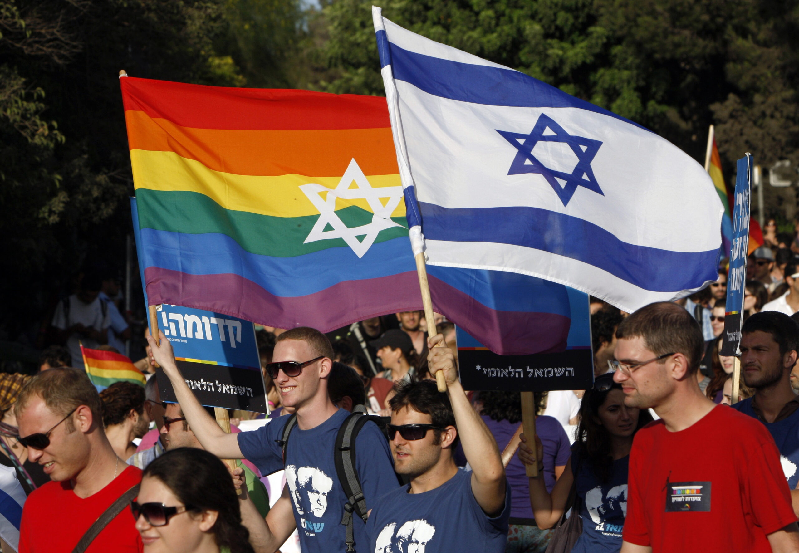 Participants hold flags during the gay pride parade in Jerusalem July 29, 2010. This year's parade marks the one-year anniversary of a shooting attack in a gay and lesbian youth center in Tel Aviv, in which two people were killed and 13 were injured. REUTERS/Ronen Zvulun (JERUSALEM - Tags: POLITICS SOCIETY) (Reuters)