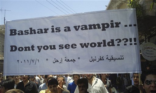In this citizen journalism image made on a mobile phone and provided by Shaam News Network, anti-Syrian President Bashar Assad protesters, hold up a banner against Assad during a demonstration against the Syrian regime, in Kfar Nebel village near the the province of Edlib, northwest Syria, on Friday July 1, 2011. Human rights activists say three people have been killed as tens of thousands of Syrians shouting for President Bashar Assad to leave office take to the streets across the country. (AP Photo/Shaam News Network) EDITORIAL USE ONLY, NO SALES, THE ASSOCIATED PRESS IS UNABLE TO INDEPENDENTLY VERIFY THE AUTHENTICITY, CONTENT, LOCATION OR DATE OF THIS HANDOUT PHOTO (AP)
