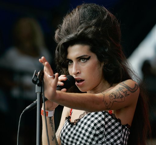 FILE - In this Aug. 5, 2007 file photo, British singer Amy Winehouse performs at Lollapalooza at Grant Park in Chicago. The singer was found dead Saturday, July 23, 2011, by ambulance crews who were called to her home in north London's Camden area. She was 27. (AP Photo/Brian Kersey, File) (AP)
