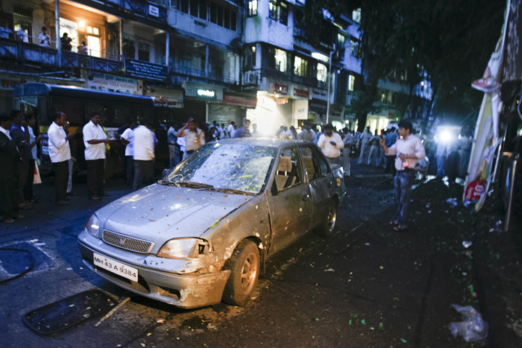 A car is seen damaged at the site of a bomb explosion in the Dadar area of Mumbai July 13, 2011. Three explosions rocked crowded districts of India's financial capital of Mumbai during rush hour on Wednesday, killing at least eight people, media said, in the biggest attack on the city since 2008 assaults blamed on Pakistan-based militants.    REUTERS/Stringer   (INDIA - Tags: CIVIL UNREST CRIME LAW) (Â© Stringer India / Reuters)