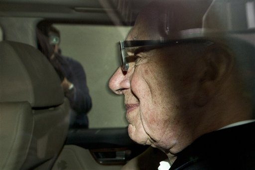 News Corporation chairman Rupert Murdoch arrives at his residence in central London, Wednesday, July 13, 2011. News Corporation announced Wednesday it has dropped its bid to takeover British Sky Broadcasting (BskyB), after the British tabloid newspaper News of the World is accused of hacking into the mobile phones of various crime victims, celebrities and politicians.(AP Photo/Sang Tan) (AP)