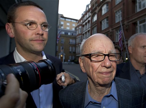 Chairman of News Corporation Rupert Murdoch, right, and his son James Murdoch, chief executive of News Corporation Europe and Asia arrive at his residence in central London, Sunday, July 10, 2011. News of the World cease publication with Sunday issue the last. News of the World is accused of hacking into the mobile phones of crime victims, celebrities and politicians. (AP Photo/Sang Tan) (AP)