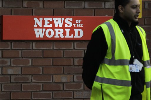 A security officer stands at the gates outside the publisher of News of the World, News International's headquarters in London, Thursday, July 7, 2011.  Sunday newspaper News of the World is accused of hacking into the mobile phones of crime victims, celebrities and politicians, prompting News International to announce Thursday that the papers is to cease publication after publication upcoming Sunday. (AP Photo/Sang Tan) (AP)
