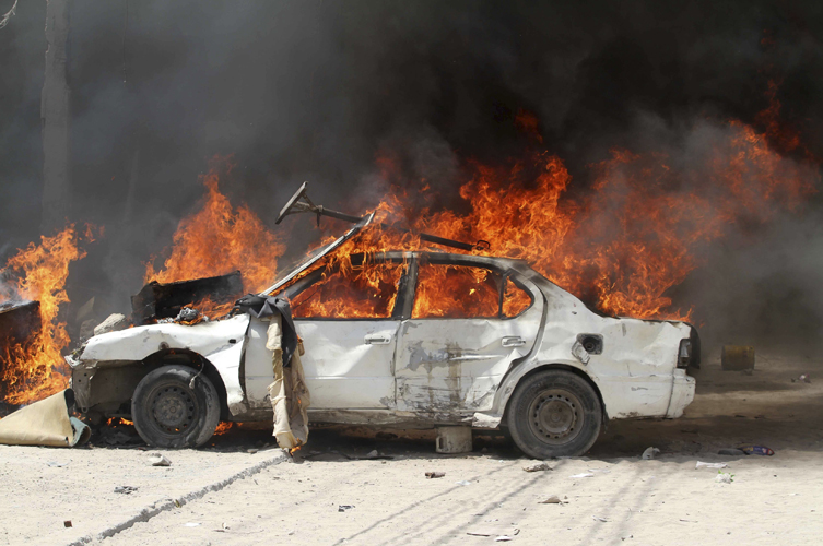 A car burns outside Hotel Madina during a protest in support of Prime Minister Mohamed Abdullahi Mohamed, in the streets of Somalia's capital Mogadishu, June 10, 2011. Two boys were shot dead in Somalia's capital Mogadishu on Friday during a second day of protests against a deal to extend the mandates of the country's president and parliament, residents said. REUTERS/Feisal Omar (SOMALIA - Tags: CIVIL UNREST POLITICS) (Â© Feisal Omar / Reuters)