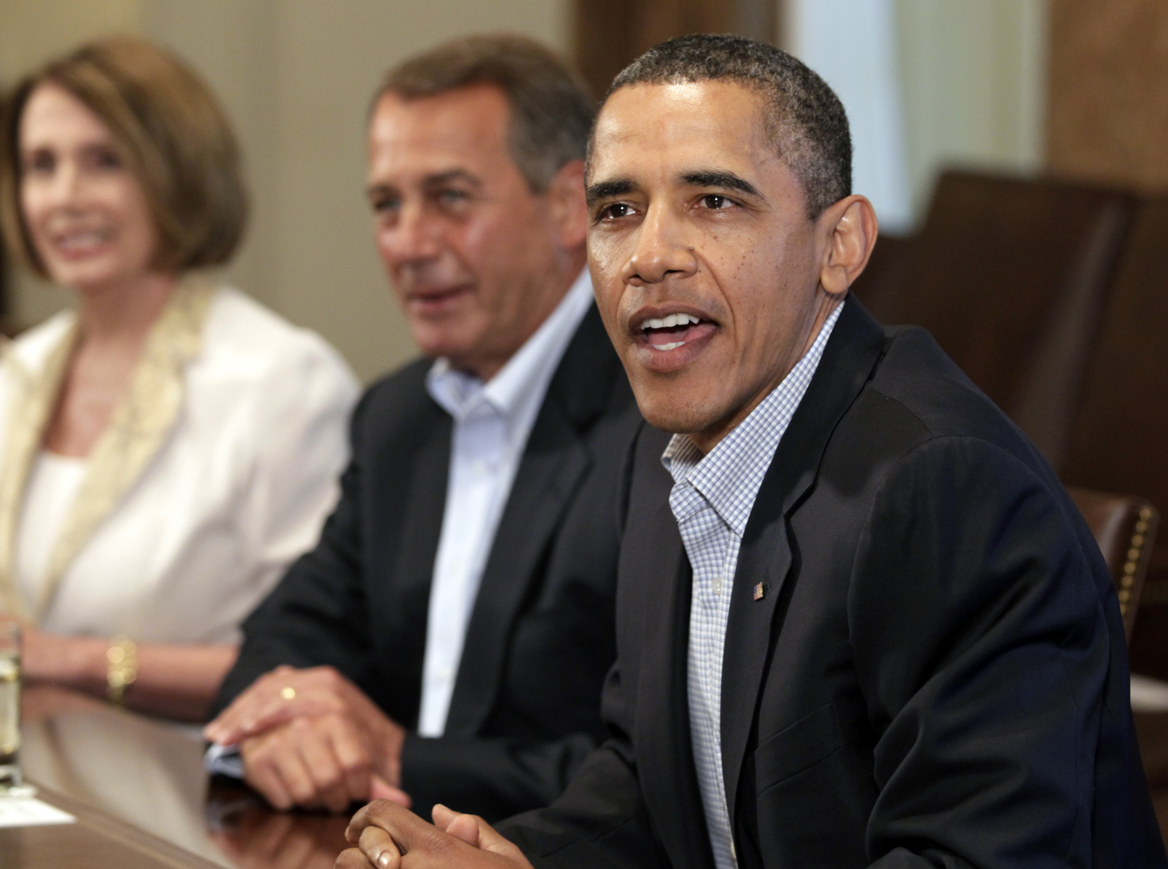 President Barack Obama meets with congressional leadership in the Cabinet Room of the White House,Sunday, July 10, 2011, in Washington, to discuss the debt House Democratic Leader Nancy Pelosi of Calif., left, and House Speaker John Boehner. (AP Photo/Carolyn Kaster) (Associated Press)