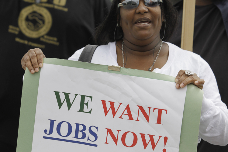 Unemployed Deanna Rice holds up a sign at a workers rally in San Francisco, Thursday, Sept. 16, 2010.