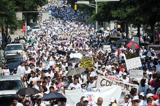Thousands of people march through downtown Atlanta in protest against Georgia's strict new immigration law on Saturday, July 2, 2011 in Atlanta. On Monday, a Federal judge temporarily blocked parts of the law. One provision that was blocked authorizes police to check the immigration status of suspects without proper identification. It also authorizes them to detain illegal immigrants. (AP Photo/Erik S. Lesser) (AP)