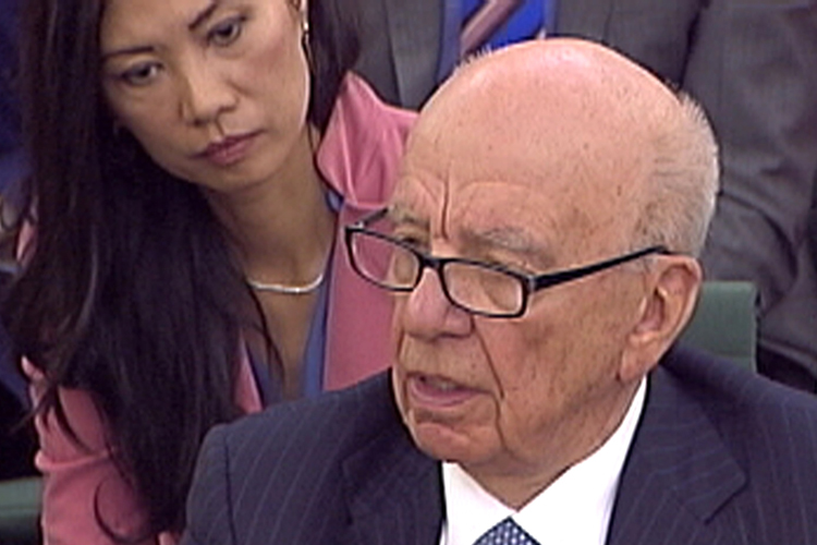 Wendi Deng ( L) watches as her husband, News Corp Chief Executive and Chairman Rupert Murdoch, is questioned during a parliamentary committee hearing on phone hacking at Portcullis House in London July 19, 2011.  Later, Murdoch was attacked by a protester on Tuesday while giving evidence to a British parliamentary committee at which he defended his son and his company over a scandal that has rocked the British establishment. REUTERS/Parbul TV via Reuters Tv (BRITAIN - Tags: CRIME LAW MEDIA BUSINESS) FOR EDITORIAL USE ONLY. NOT FOR SALE FOR MARKETING OR ADVERTISING CAMPAIGNS (Â© Reuters Tv / Reuters)