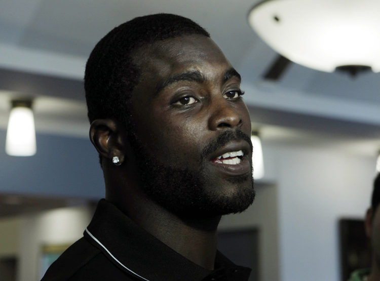 Philadelphia Eagles quarterback Michael Vick answers a question in Philadelphia, Wednesday, June 8, 2011, he says that he uses Unequal Technologies EXO Skeleton products that protect players like him from sports-related hard-hit injuries. (AP Photo/Mel Evans) (Mel Evans)