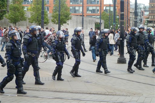 Riot police patrol Manchester city centre after trouble  on Market street  in Manchester city centre, England,  Tuesday Aug. 9, 2011.  Britain began flooding London's streets with 16,000 police officers Tuesday, nearly tripling their presence as the nation feared its worst rioting in a generation would stretch into a fourth night. The violence has turned buildings into burnt out carcasses, triggered massive looting and spread to other U.K. cities.   (AP Photo /  Dave Thompson / PA)  UNITED KINGDOM OUT NO SALES NO ARCHIVE (AP)