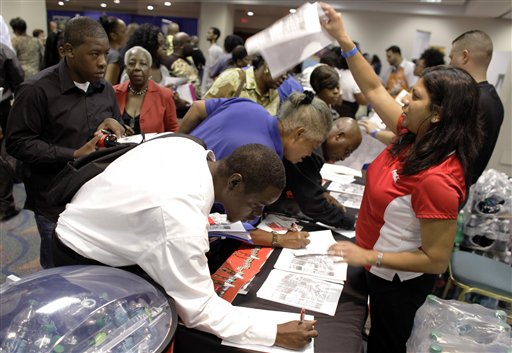 Coca-Cola employee Farrah Deonarine of Weston, Fla., right, passes out forms at a jobs fair hosted by the Congressional Black Caucus in Miami, Tuesday, Aug. 23, 2011. The fair is aimed at lowering the especially high rate of unemployment in the black community.  (AP Photo/Lynne Sladky) (AP)