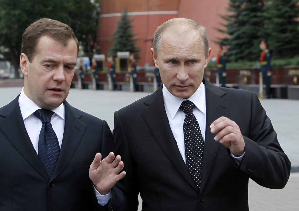 Russian President Dmitry Medvedev (L) and Prime Minister Vladimir Putin talk after a remembrance ceremony at the Tomb of the Unknown Soldier in Moscow, June 22, 2011. Russia marks on Wednesday the 70th anniversary of the start of the Soviet war against Nazi Germany, known to Russians as "The Great Patriotic war".  REUTERS/Dennis Sinyakov  (RUSSIA - Tags: ANNIVERSARY CONFLICT POLITICS) (Â© Denis Sinyakov / Reuters)