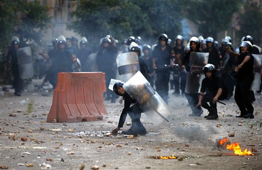 Egyptian riot police and demonstrators throw stones at each other during clashes in Cairo, early Wednesday, June 29, 2011