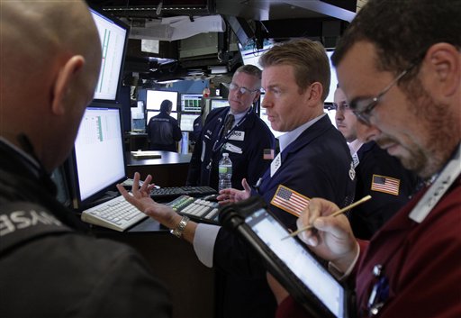 Specialist Michael O'Mara, center, works with traders at the closing bell, on the floor of the New York Stock Exchange Friday, Aug. 12, 2011. A wild week ended relatively calmly on Wall Street Friday as the Dow today gained 126 points to 11,269 and the S&P was up 6 points, while the Nasdaq composite added 15 points. The key averages were down 1 percent or more for the week. (AP Photo/Richard Drew) (AP)