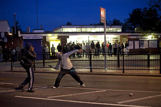 Youths throw bricks at police Sunday, Aug. 7, 2011 during unrest in Enfield, North London. New unrest erupted on north London's streets late Sunday, a day after rioting and looting in a deprived area amid community anger over a fatal police shooting. (AP Phto/Karel Prinsloo) (AP)