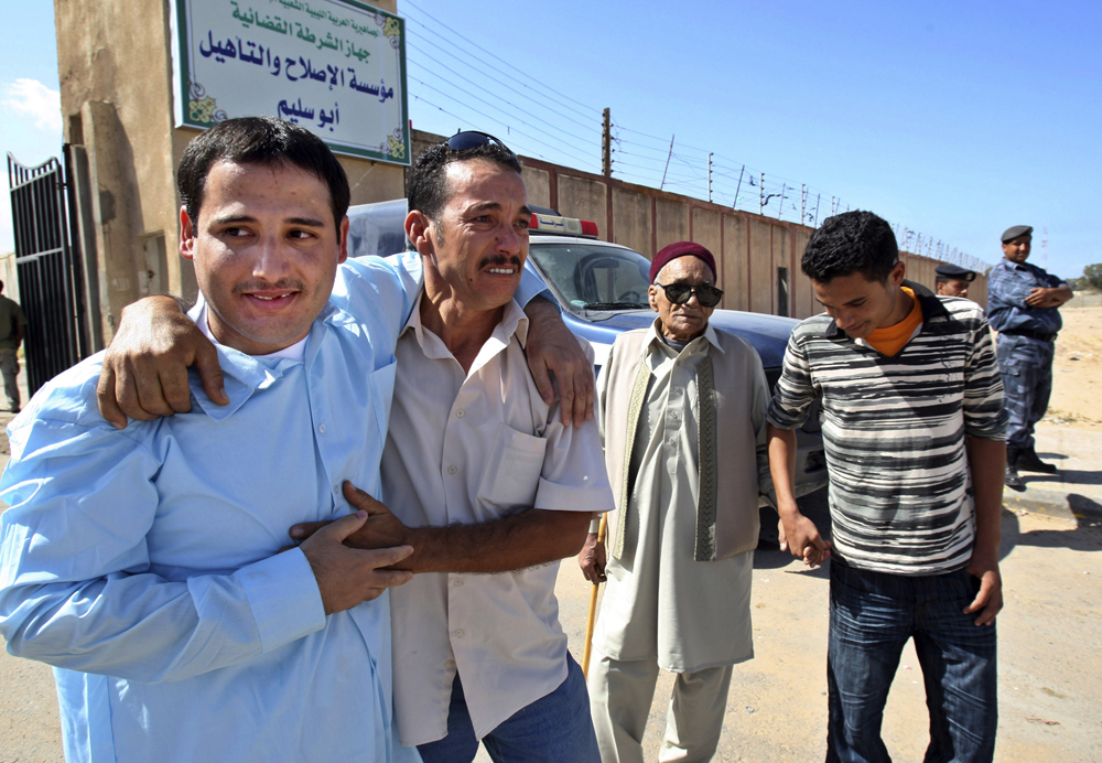 A former Libyan prisoner, left, is greeted by his relatives after being released from Abu Salim in Tripoli, Libya, Thursday, Oct. 15, 2009