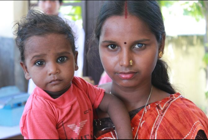 Sunita Thakur holds her son while she waits to receive family planning counseling at the Institutional Clinic and Training Center in Nepal