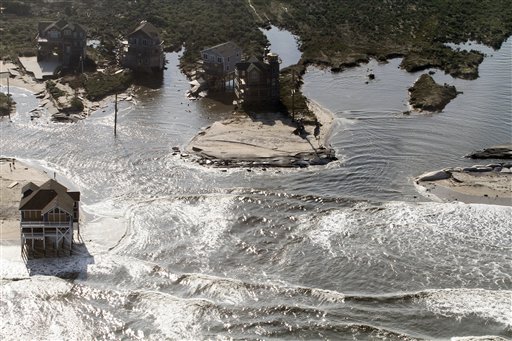 A flooded road is seen in Hatteras Island, N.C., Sunday, Aug. 28, 2011after Hurricane Irene swept through the area Saturday cutting the roadway in five locations. Irene caused more than 4.5 million homes and businesses along the East Coast to reportedly lose power over the weekend, and at least 11 deaths were blamed on the storm.(AP Photo/Jim R. Bounds) (AP)