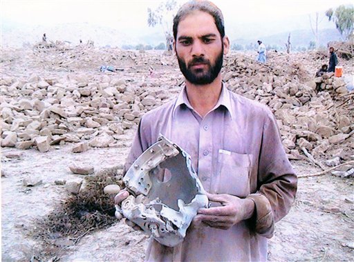 In this Aug. 23, 2010 photo provided by photographer Noor Behram, a man holds debris from a missile strike in North Waziristan, Pakistan. A gallery in London is staging an exhibit of photographs taken by a Pakistani photographer allegedly showing innocent civilians killed by U.S. drone missile strikes in Pakistan's tribal region along the Afghan border, the organizers said Monday. Noor Behram, a 39-year-old photographer who has worked with several international news agencies, has spent the last three years photographing the aftermath of drone strikes in North and South Waziristan, important sanctuaries for al-Qaida and Taliban militants in Pakistan. He said he has managed to reach around 60 attack sites, and the exhibit that opens Tuesday at the Beaconsfield gallery in London features photographs from 28 of those strikes. (AP Photo/Noor Behram,HO) (AP)