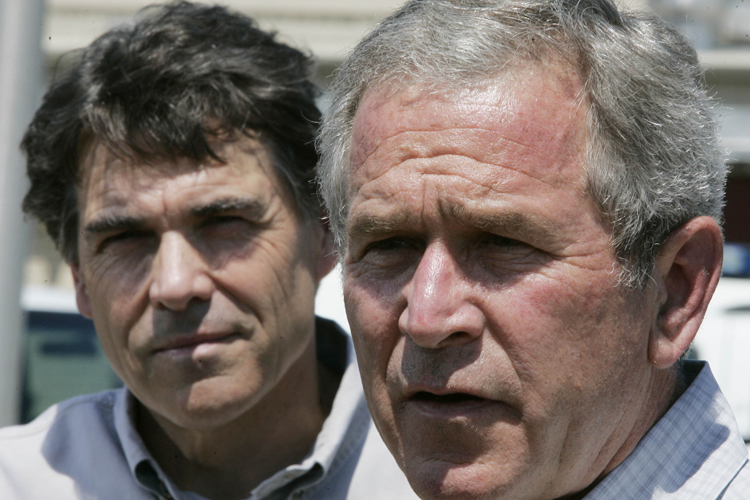 Former president Bush, right, speaks to reporters as Texas Gov. Rick Perry looks on during their visit to the Laredo Border Patrol Sector Headquarters near the U.S.-Mexico border in Laredo, Texas, Tuesday, June 6, 2006.