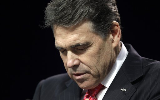 Texas Gov. Rick Perry bows his head as he leads a  prayer at The Response, a call to prayer for a nation in crisis, Saturday, Aug. 6, 2011, in Houston. Perry attended the daylong prayer rally despite criticism that the event inappropriately mixes religion and politics. (AP Photo/David J. Phillip) (AP)