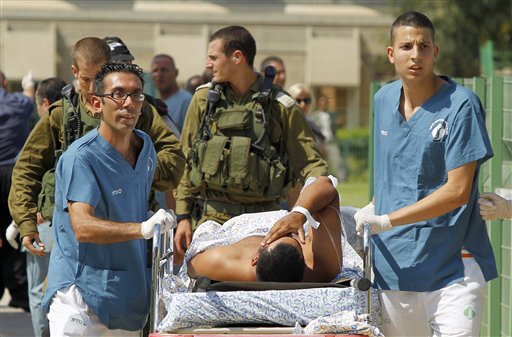 Israeli medics evacuate a person wounded in one of several attacks in the Arava desert, to the Soroka hospitan in Beersheba, southern Israel, Thursday, Aug. 18, 2011. Assailants armed with heavy weapons, guns and explosives crossed into southern Israel from the neighboring Egyptian Sinai peninsula on Thursday, killing six Israelis and wounding at least a dozen more in an audacious string of attacks that stoked concerns about Palestinian militants exploiting the recent instability in Egypt. (AP Photo/Ilan Assayag) ISRAEL OUT (AP)