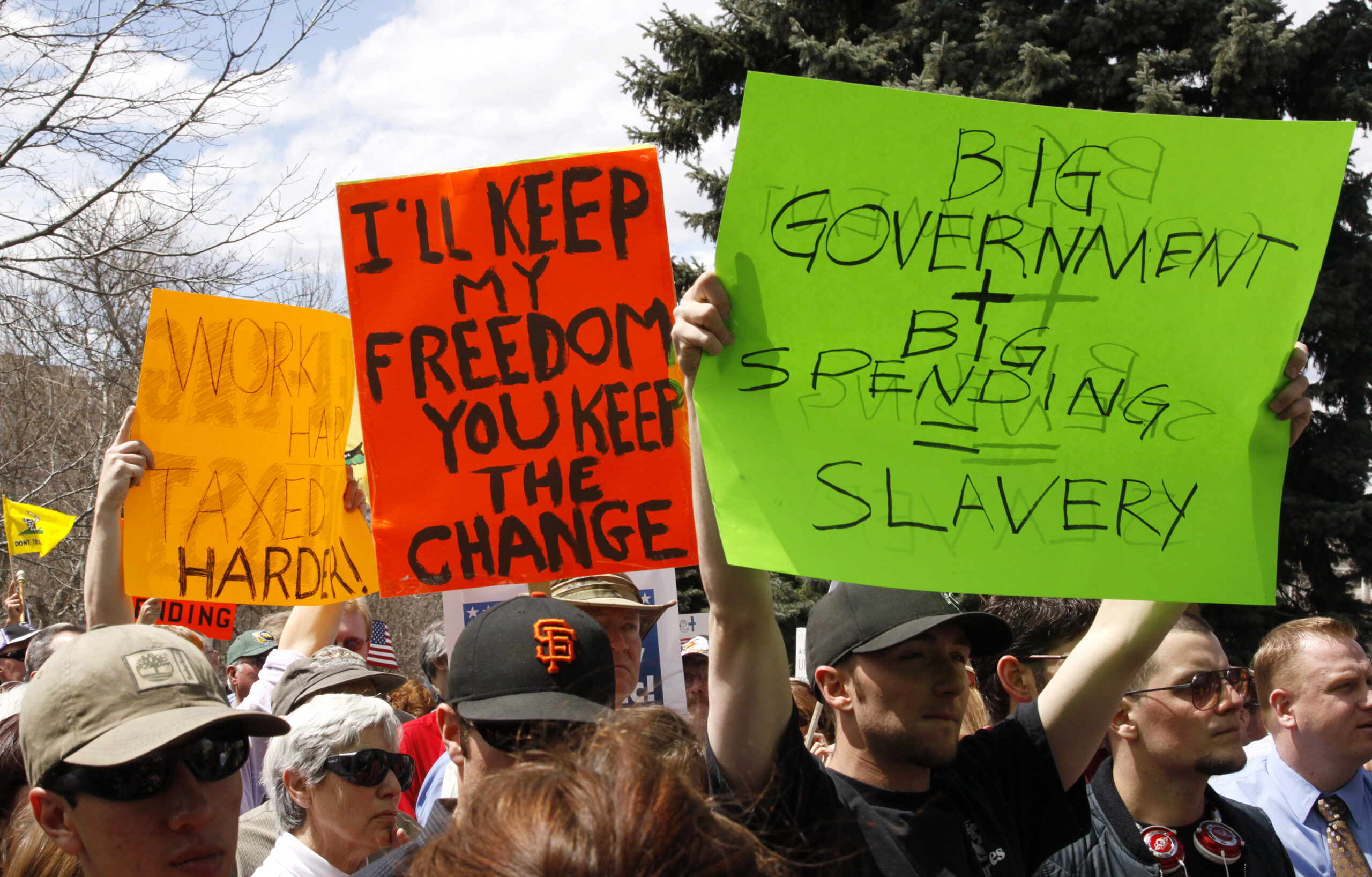 People wave signs at a "tea party" protest on the grounds of the Colorado state capitol in Denver April 15, 2009 (Reuters)