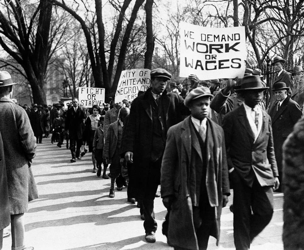 In this March 6, 1930 file photo, groups of unemployed gather in front of the White House before parading in protest in Washington