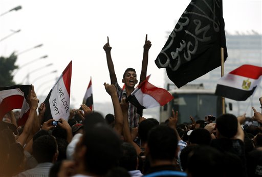 Egyptians chant anti-Israeli slogans as they hold Egyptian and Palestinian flags to protest the death of Egyptian security forces killed in a shootout between Israeli soldiers and Palestinian militants on Thursday in the Sinai, in front of the Israeli embassy in Cairo, Egypt, Saturday, Aug. 20, 2011. Egypt said Saturday it would recall its ambassador from Israel to protest the deaths, sharply escalating tensions between the neighboring countries, whose 1979 peace treaty is being tested by the fall of Egypt's longtime autocratic leader, Hosni Mubarak. (AP Photo/Khalil Hamra) (AP)
