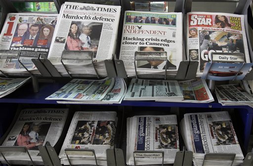 Newspapers for sale with headlines relating to the phone hacking scandal, near Westminster in London, Wednesday, July 20, 2011. Prime Minister David Cameron on Wednesday emphatically denied claims that his staff tried to stop an inquiry into phone hacking at the News of the World newspaper and defended his decision to hire one of the tabloid's editors as his communications chief.  (AP Photo/Kirsty Wigglesworth) (AP)