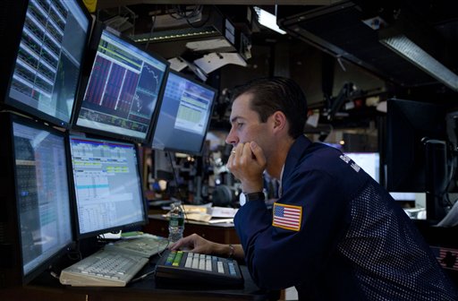 In this Aug. 4, 2011 photo, a trader works on the floor of the New York Stock Exchange. Global stock markets tumbled Friday, Aug. 5, amid fears the U.S. may be heading back into recession and Europe's debt crisis is worsening. The sell-off follows the biggest one-day points decline on Wall Street since the 2008 financial crisis. (AP Photo/Jin Lee) (AP)
