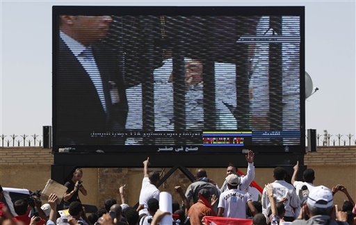Egypt's ousted President Hosni Mubarak  is seen on a TV screen as he enters the courtroom on a hospital bed, outside the  Police Military Academy complex in Cairo, Egypt Wednesday, Aug. 3, 2011. Egypt's ousted President Hosni Mubarak was wheeled into a Cairo courtroom on a gurney Wednesday at the start of his historic trial on charges of corruption and ordering the killing of protesters during the uprising that ousted him. The scene, shown live on Egypt's state TV, was Egyptians' first look at their former president since Feb. 10, the day before his fall when he gave a defiant speech refusing to resign. (AP Photo/Nasser Nasser) (AP)