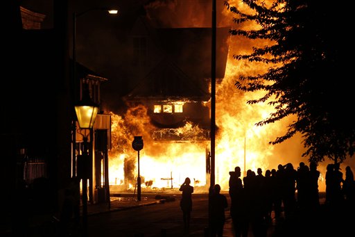 A shop is set on fire as rioters gathered in Croydon, south London, Monday, Aug. 8, 2011. Violence and looting spread across some of London's most impoverished neighborhoods on Monday, with youths setting fire to shops and vehicles, during a third day of rioting in the city that will host next summer's Olympic Games. (AP Photo/Sang Tan) (AP)