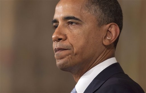 President Barack Obama pauses as he speaks in the State Dining Room of the White House in Washington, Monday, Aug. 8, 2011.  (AP Photo/Evan Vucci) (AP)