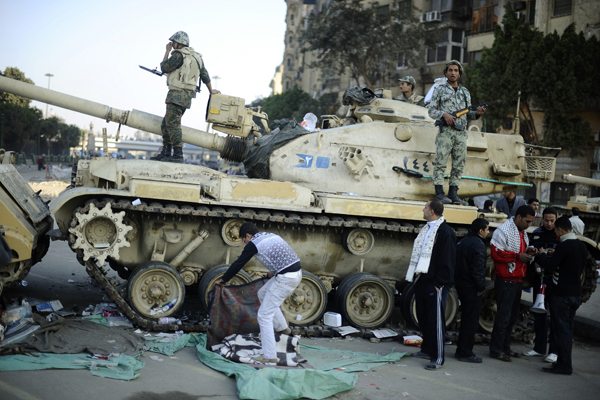 Egyptian soldiers stand on a tank in Cairo (Dylan Martinez / Reuters)