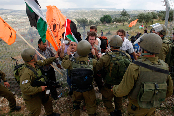 Protesters are forced back by Israeli security force officers in the West Bank village of Bilin. (Reuters/Mohamad Torokman )