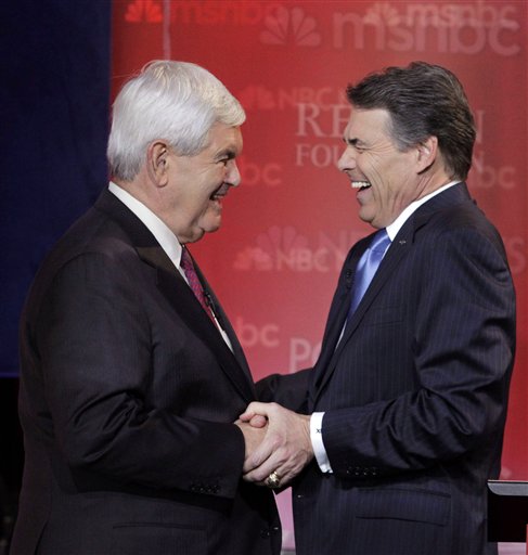 Republican presidential candidates former House Speaker Newt Gingrich, left, and Texas Gov. Rick Perry share a laugh during a break at a Republican presidential candidate debate at the Reagan Library Wednesday, Sept. 7, 2011, in Simi Valley, Calif.  (AP Photo/Jae C. Hong) (AP)