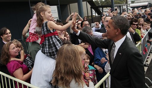 President Barack Obama, right, greets guests on the tarmac during his arrival at King County International Airport/Boeing Field, Sunday, Sept., 25, 2011, in Seattle, Wash.  (AP Photo/Pablo Martinez Monsivais) (AP Photo/Pablo Martinez Monsivais)