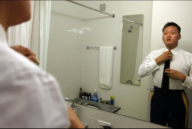 Dan Choi gets dressed into his uniform in his Manhattan apartment