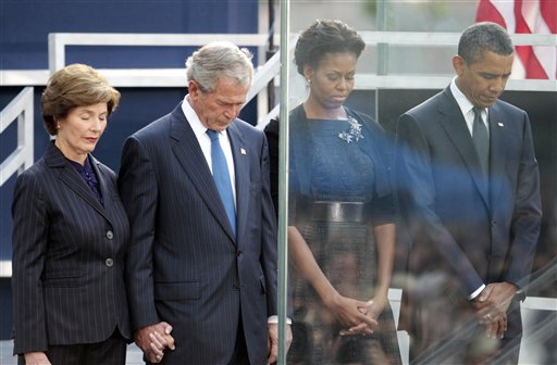 President Barack Obama and first lady Michelle Obama, former President George W. Bush and former first lady Laura Bush bow their heads during a moment of silence at the Sept. 11 10th Anniversary Commemoration Ceremony at Ground Zero in New York, Sunday, Sept., 11, 2011 in New York. (AP Photo/Pablo Martinez Monsivais) (AP)
