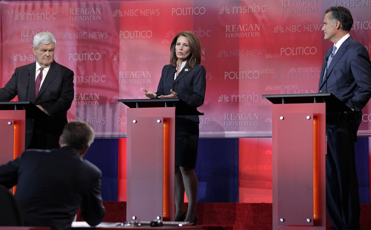 Republican presidential candidates former House Speaker Newt Gingrich, left, and former Massachusetts Gov. Mitt Romney, right, listen as Rep. Michele Bachmann, R-Minn., speaks during a Republican presidential candidate debate at the Reagan Library Wednesday, Sept. 7, 2011, in Simi Valley, Calif.  (AP Photo/Jae C. Hong) (Jae C. Hong)