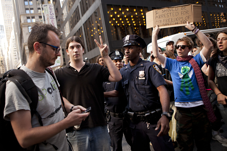 Laurentiu Garofeanu, left, and a second protestor participating in the "Occupy Wall Street"  protests, are arrested by the New York City police officers outside Zuccotti Park in New York, on Monday, Oct. 10, 2011. (AP/Andrew Burton)