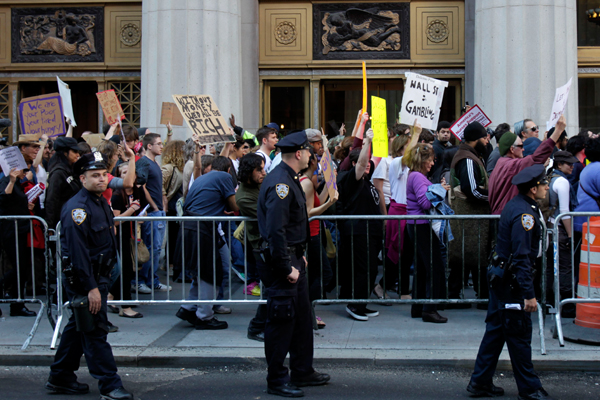 Police escort Occupy Wall Street protesters marching in New York on Wednesday. (AP/Seth Wenig)