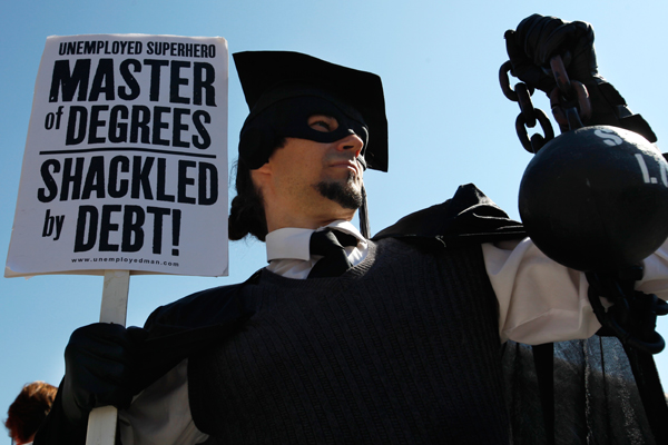 At Occupy DC, a protester holds a ball and chain representing his college loan debt on October 6, 2011 (AP/Jacquelyn Martin)