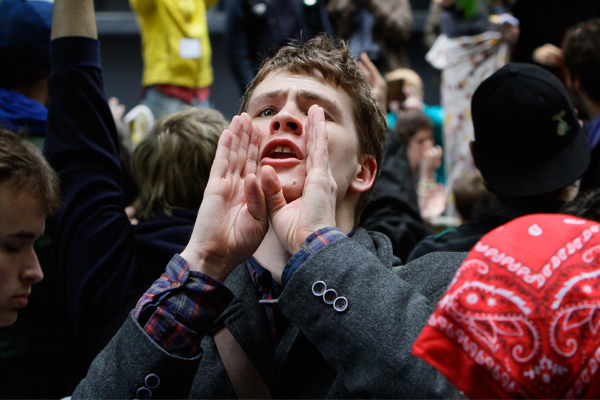A protestor takes on the role of a human microphone, relaying information throughout Zuccotti Park's Occupy Wall Street encampment. (AP/Bebeto Matthews)