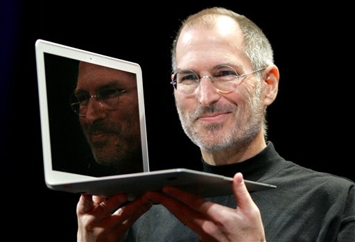 Apple CEO Steve Jobs holds up the new MacBook Air after giving the keynote address at the Apple MacWorld Conference in San Francisco in 2008. (AP Photo/Jeff Chiu, File)