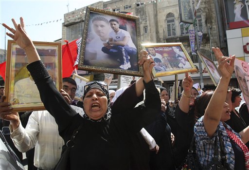 Palestinians participate in a demonstration in solidarity with prisoners jailed in Israel in the West Bank city of Nablus, Tuesday Oct. 11, 2011. (AP/Nasser Ishtayeh)